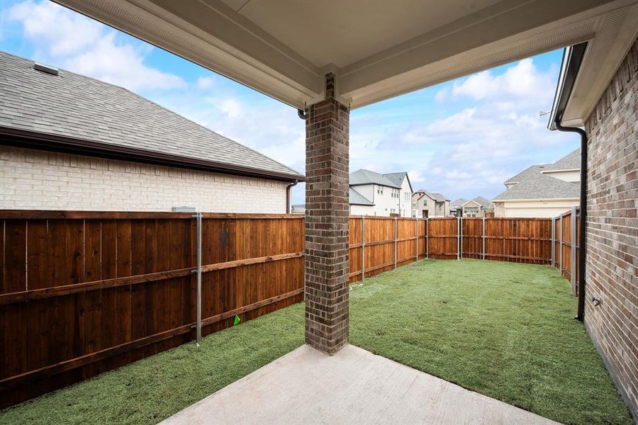Fenced backyard with a patio and a residential view Fenced backyard with a patio and a residential view
