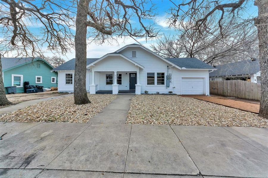 Bungalow-style house with a garage, covered porch, and roof with shingles Bungalow-style house with a garage, covered porch, and roof with shingles