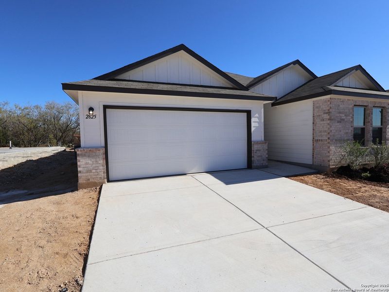 Front exterior of a new home in Greenspoint Heights, Seguin, TX, highlighting curb appeal (Image 22). Front exterior of a new home in Greenspoint Heights, Seguin, TX, highlighting curb appeal (Image 22).