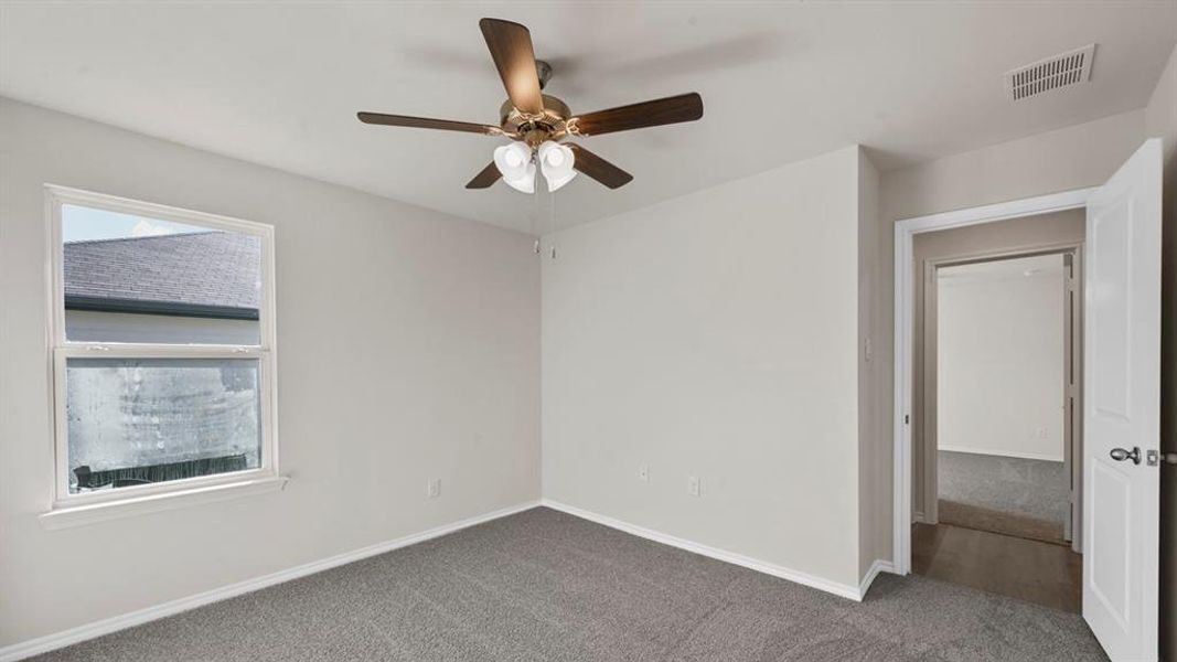 Room featuring light gray wall paint and gray carpet flooring Room featuring light gray wall paint and gray carpet flooring
