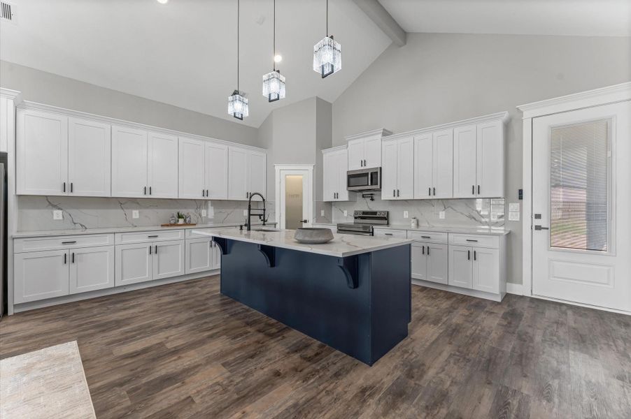 Chef’s dream kitchen featuring a large centered island with seating, perfect for family gatherings. Chef’s dream kitchen featuring a large centered island with seating, perfect for family gatherings.