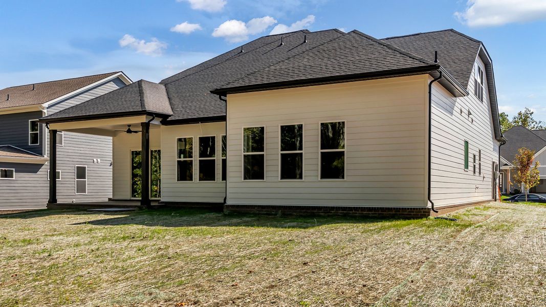 Exterior of home with covered rear porch (Representative of finished home)