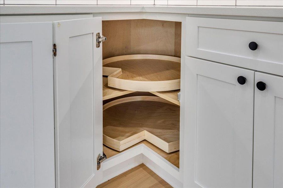 Builder optimized kitchen storage with a corner cabinet featuring two convenient lazy Susan shelves.