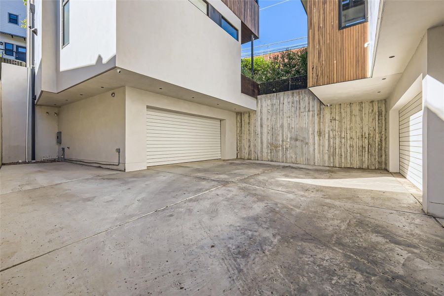 Concrete driveway leads to attached garage, providing ample parking and easy access. Concrete driveway leads to attached garage, providing ample parking and easy access.