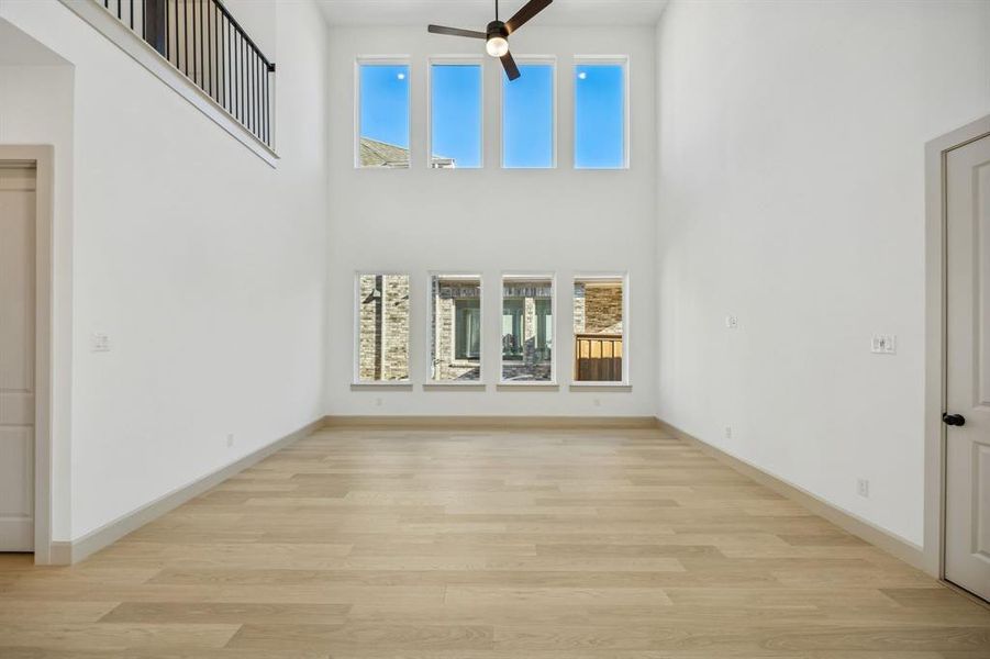 Your new family room is flooded with natural light from a double stacked wall of windows!