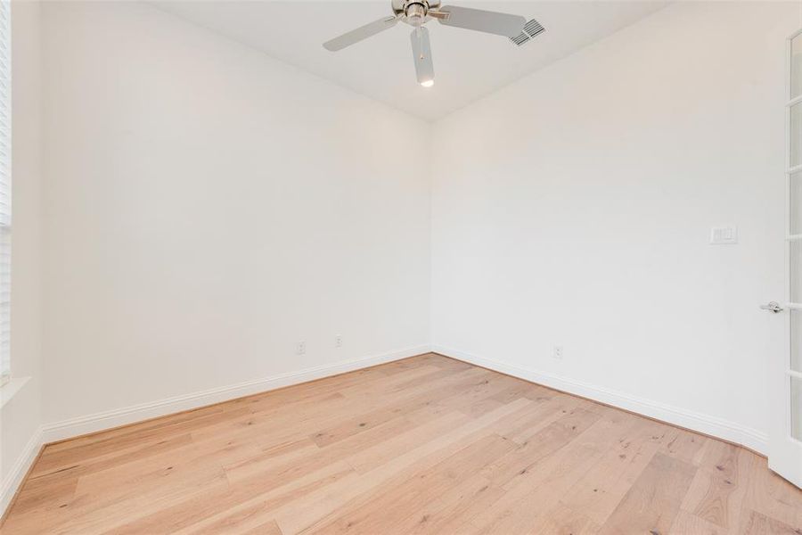 Unfurnished room featuring ceiling fan and light hardwood / wood-style flooring