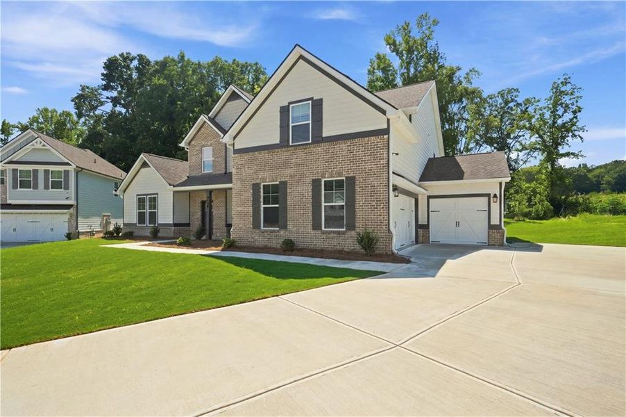 Front exterior of a new home in Grandview at Millers Mill, Stockbridge, GA, highlighting curb appeal (Image 18).