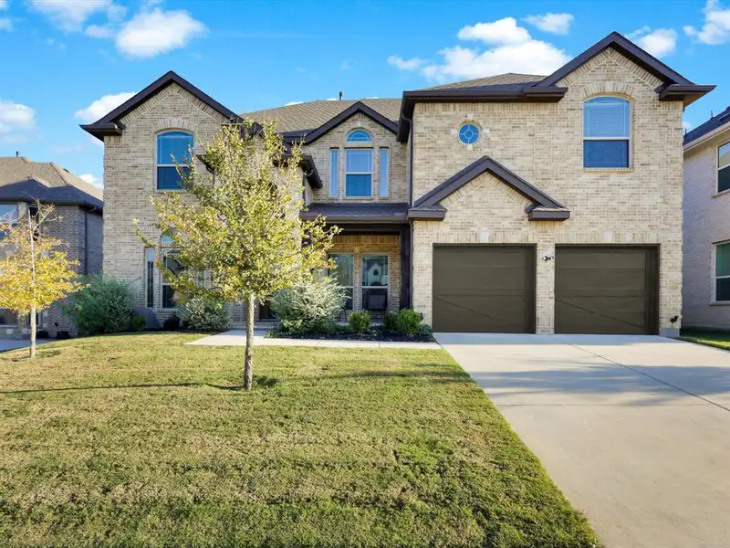 Front exterior of a new home in , Mansfield, TX, highlighting curb appeal (Image 1).