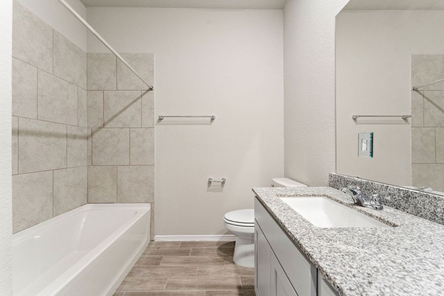A bathroom with a marble countertop.