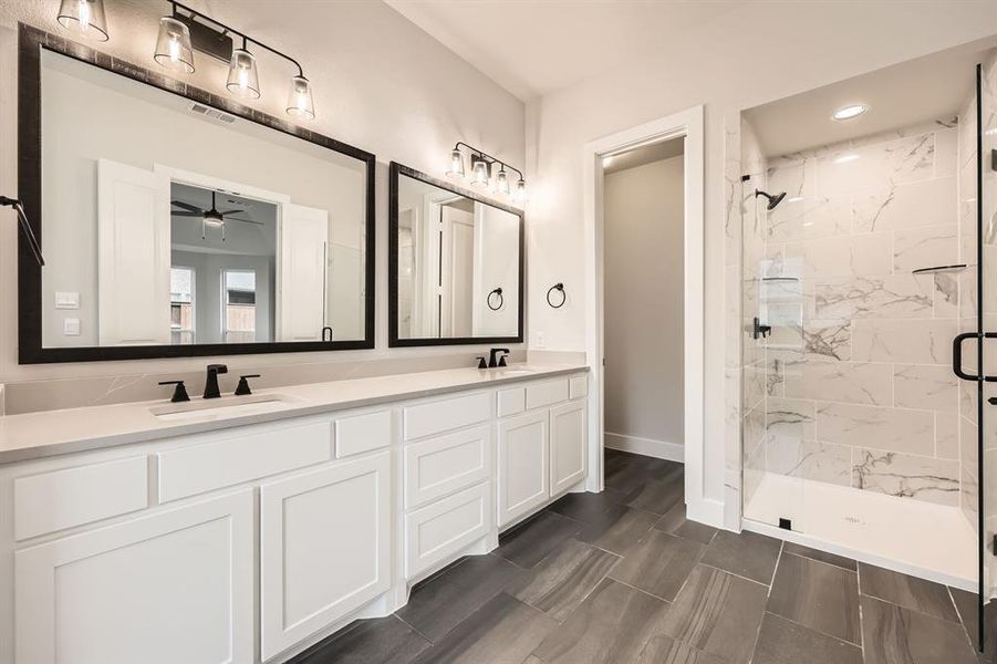 Bathroom with vanity, ceiling fan, and a shower with door