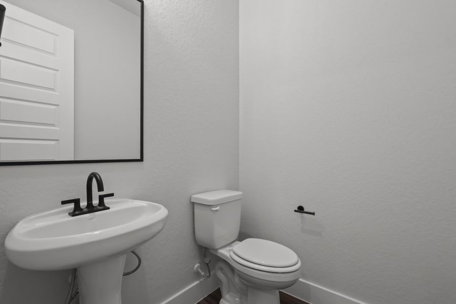 A bathroom with a toilet and sink. A bathroom with a toilet and sink.