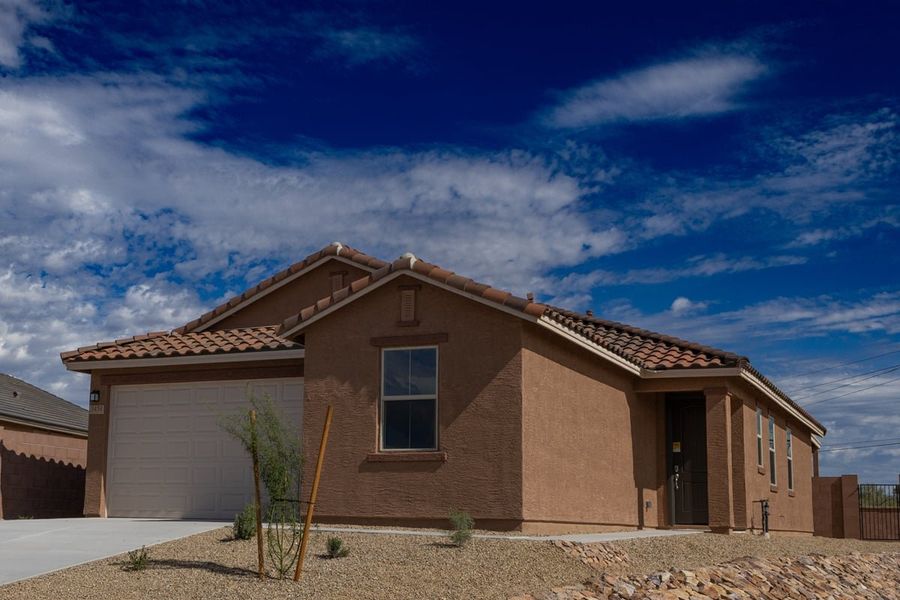 Front exterior of a new home in Colina de Anza Traditions, Tucson, AZ, highlighting curb appeal (Image 1). Front exterior of a new home in Colina de Anza Traditions, Tucson, AZ, highlighting curb appeal (Image 1).