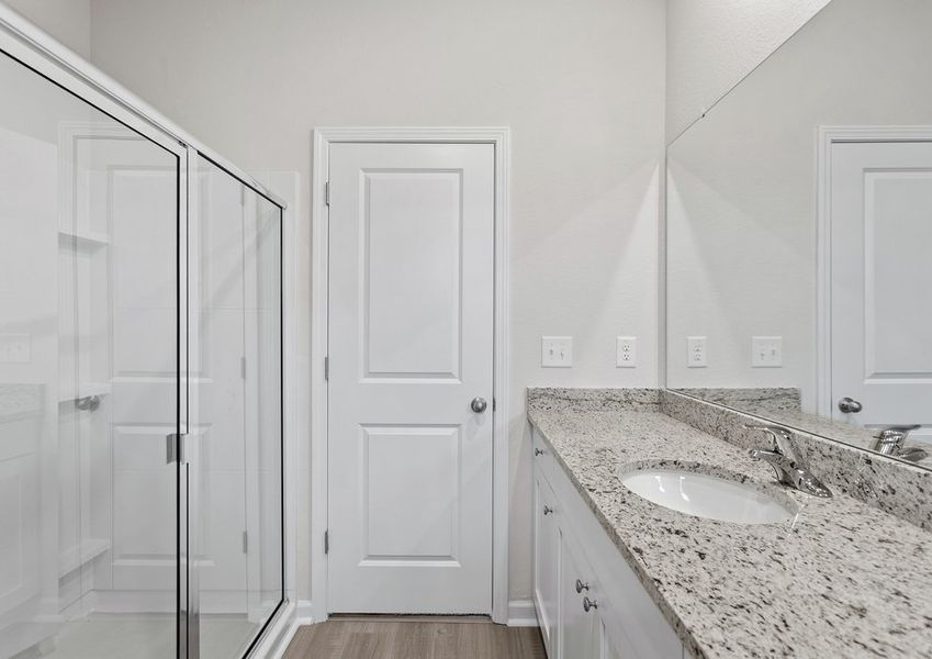 This bathroom has a glass-enclosed shower