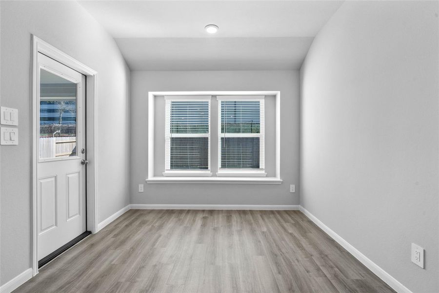 Enjoy meals in this sun-drenched space, featuring durable LVP flooring, large windows (fitted with blinds), window seat for added seating, and recessed lighting. An access door to the back covered patio is conveniently located for ease of indoor to outdoor living. Enjoy meals in this sun-drenched space, featuring durable LVP flooring, large windows (fitted with blinds), window seat for added seating, and recessed lighting. An access door to the back covered patio is conveniently located for ease of indoor to outdoor living.