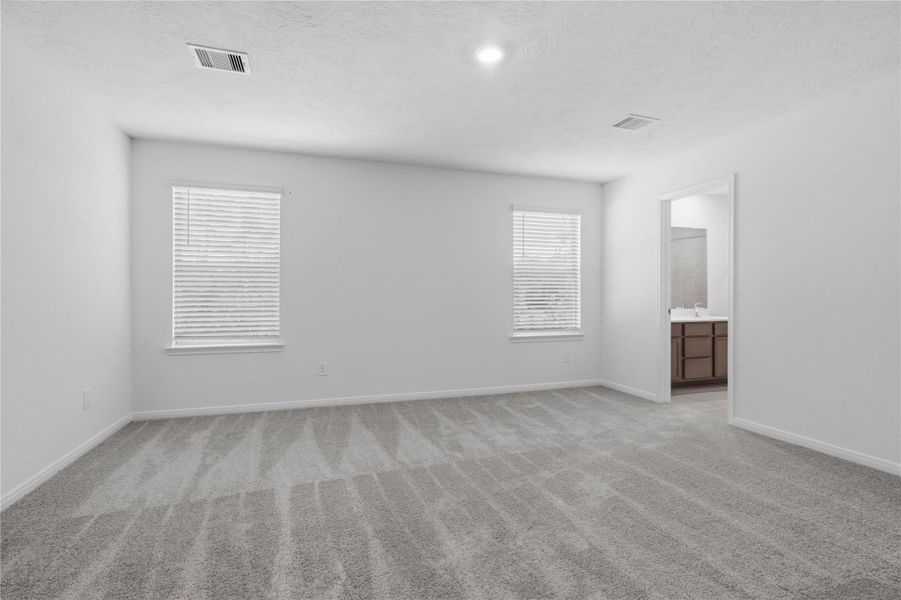 Relax and unwind after a long day in this impressive primary suite! This generously sized room offers plush carpeting, neutral-toned paint, high ceilings with recessed lighting, and large windows with privacy blinds for added comfort and tranquility. Relax and unwind after a long day in this impressive primary suite! This generously sized room offers plush carpeting, neutral-toned paint, high ceilings with recessed lighting, and large windows with privacy blinds for added comfort and tranquility.