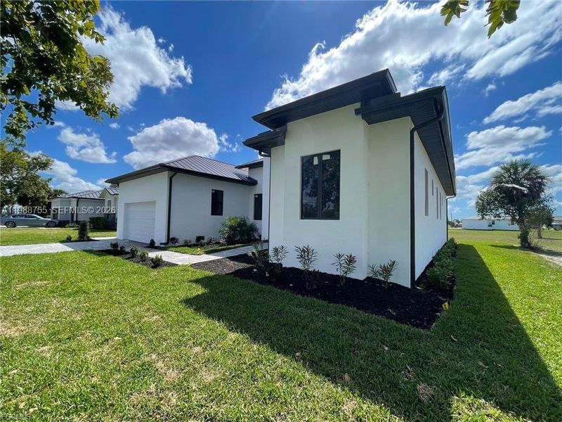 Front exterior of a new home in , Punta Gorda, FL, highlighting curb appeal (Image 16).