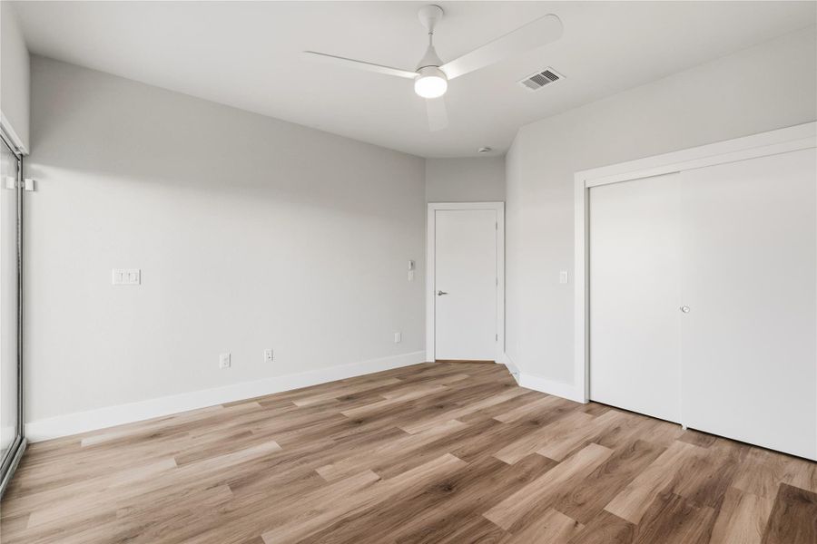 One of the secondary bedrooms spans an impressive 13×15, larger than what’s typically offered creating flexibility well beyond a standard guest room. The space includes a walk-in closet and direct access to a covered patio, making it ideal for guests, a home office, or a private retreat with indoor–outdoor flow.