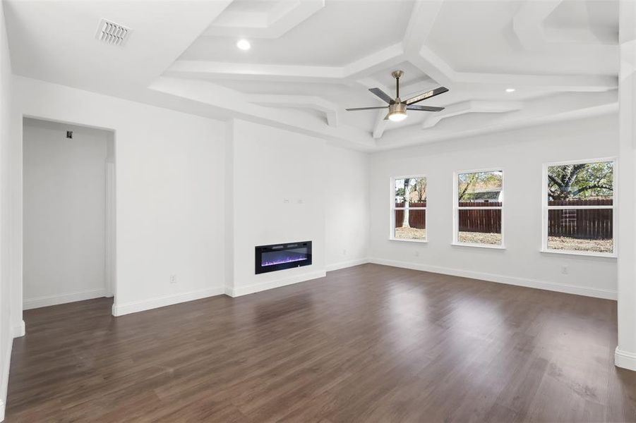 Unfurnished living room with dark hardwood / wood-style floors and ceiling fan