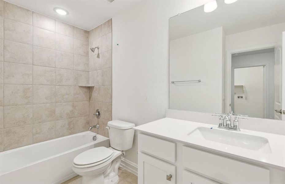 Secondary bathroom featuring modern upgrades and finishes *Real home pictured