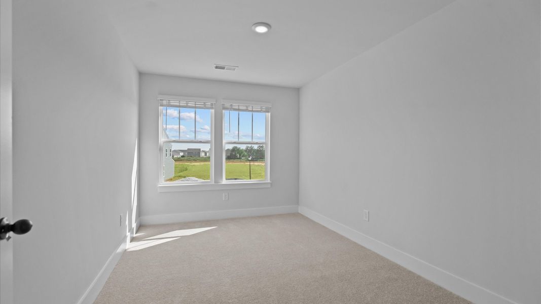 Accomplished design in this restful bedroom featuring plush carpet and oversized window views Accomplished design in this restful bedroom featuring plush carpet and oversized window views
