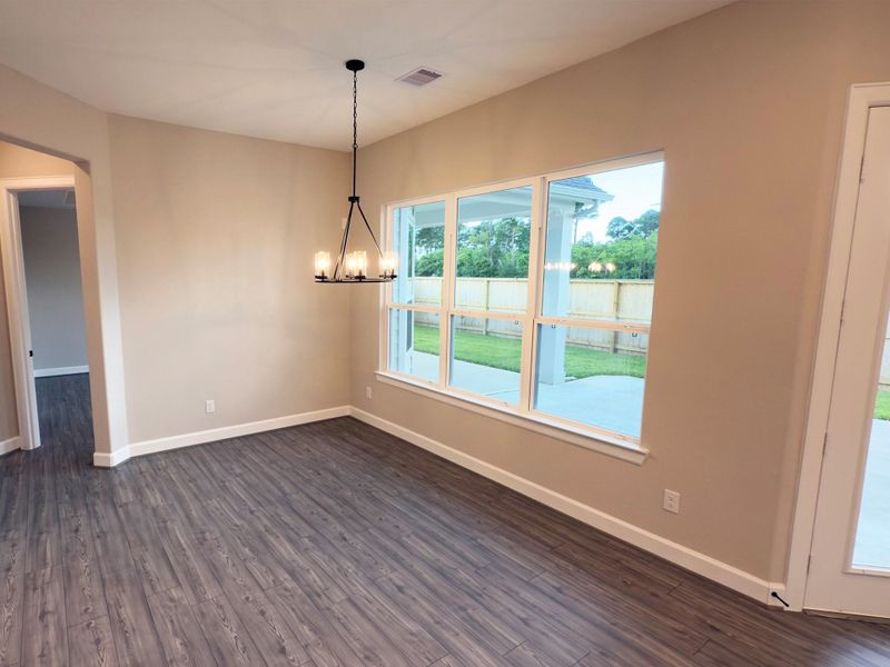 Indulge in elegance where the dining area seamlessly lends sophistication and comfort. With ample space, stunning finishes, and a warm ambiance, it provides intimate dinners and festive gatherings. *Image depicts home as-is.