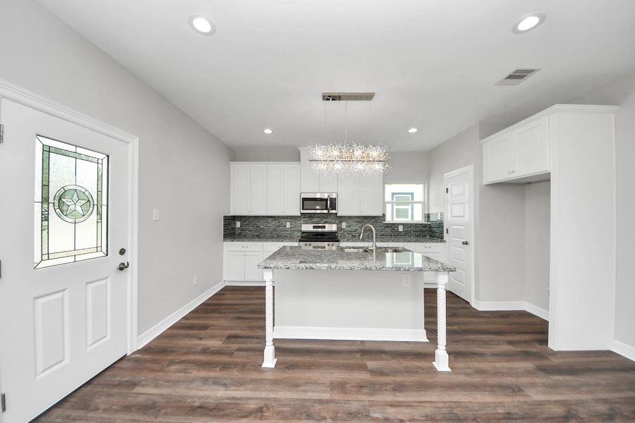 At the heart of the home, this stunning kitchen is a chef’s dream, featuring custom soft-close cabinetry, gleaming granite countertops, a spacious island with bar seating, and stainless steel appliances - (representation photo).