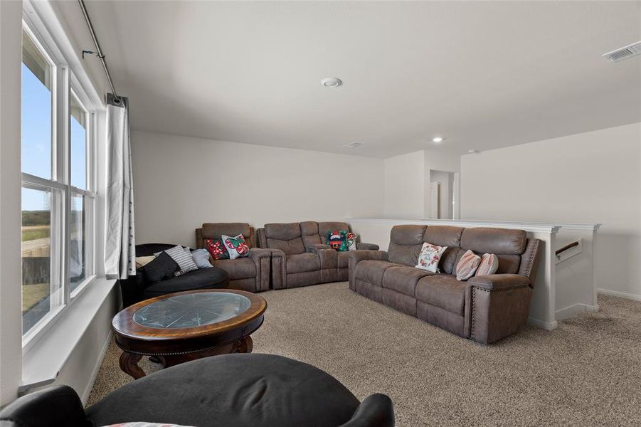 Carpeted living room featuring baseboards and recessed lighting