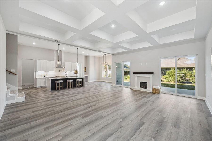 This is the view from the Foyer looking in at the Double Sliding Doors, Kitchen, Dining Room and Full Length Covered Patio