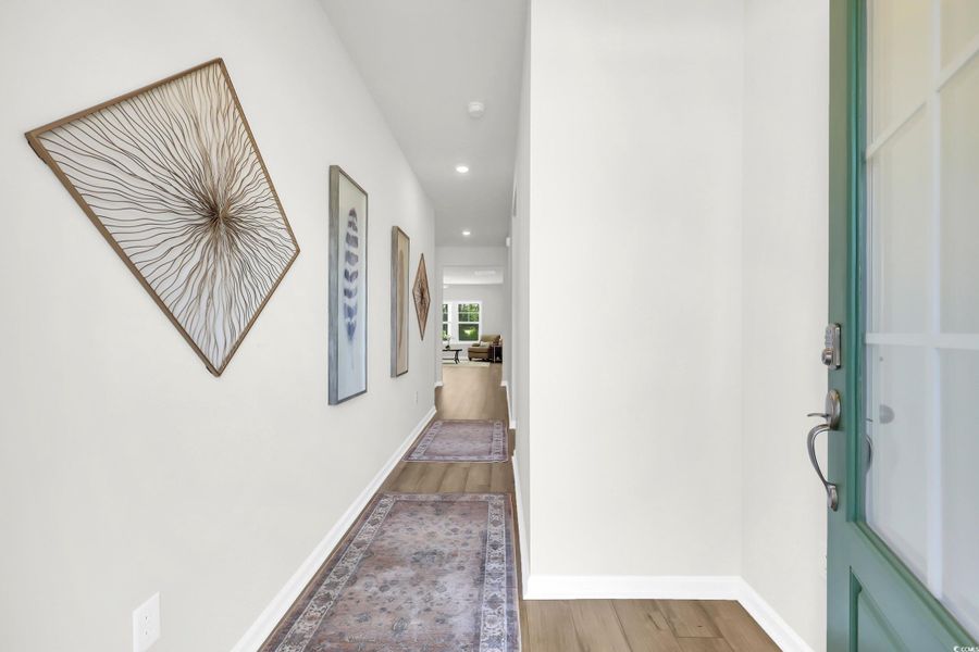 Hall with recessed lighting and light wood-style flooring Hall with recessed lighting and light wood-style flooring