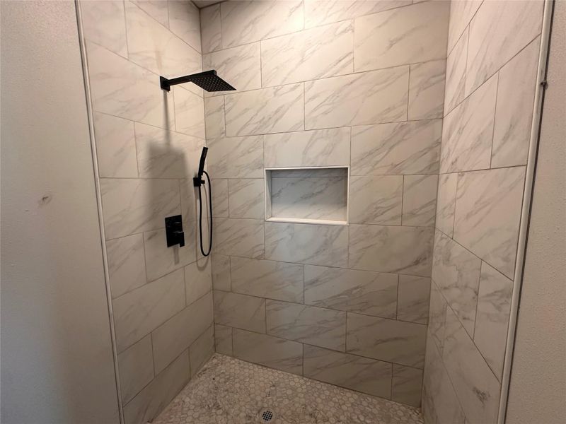 Full bathroom with a tile shower