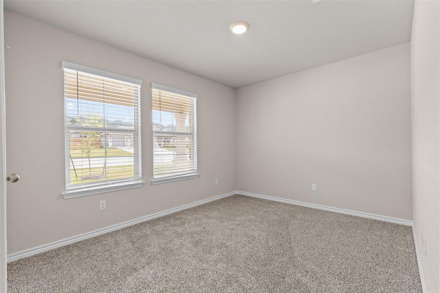 Carpeted empty room featuring baseboards