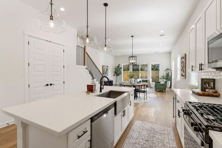 The kitchen flows seamlessly into the dining and living areas.