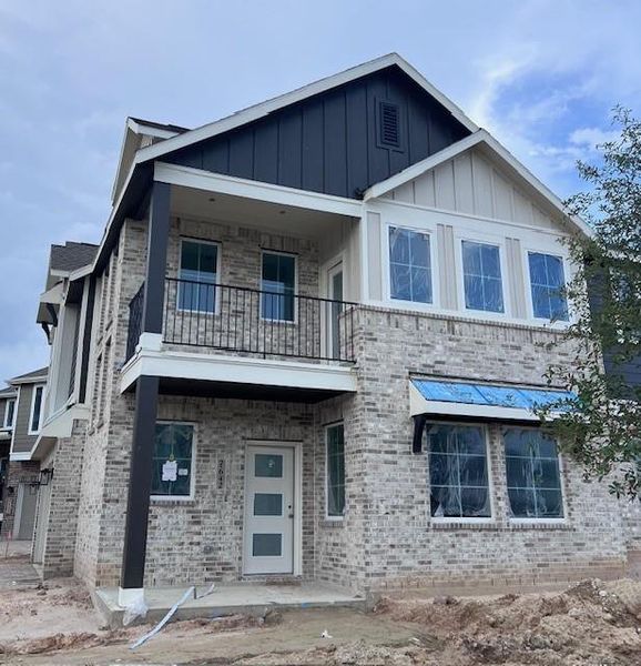 Front exterior of a new home in Elyson, Katy, TX, highlighting curb appeal (Image 1).