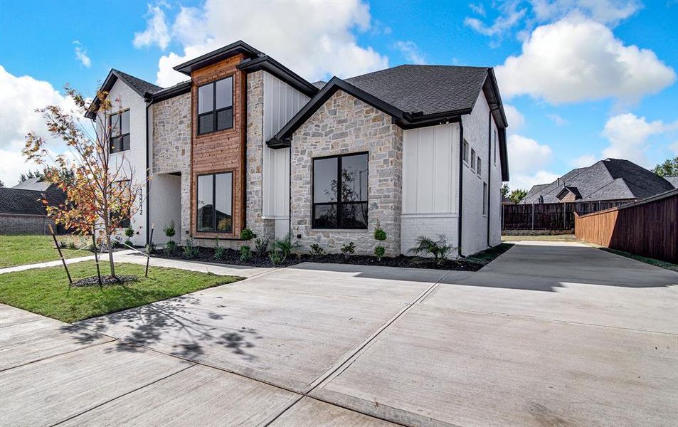 View of front facade featuring stone siding and board and batten siding View of front facade featuring stone siding and board and batten siding