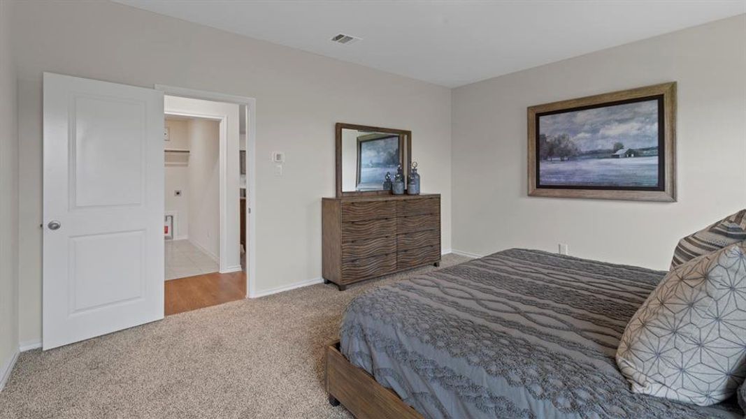 Carpeted bedroom with baseboards