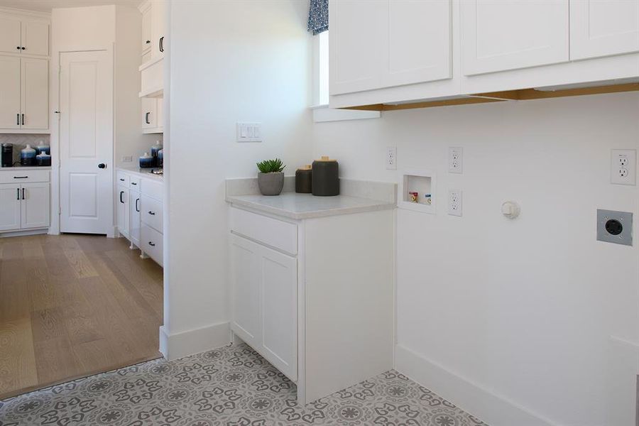 Laundry room featuring hookup for a gas dryer, cabinet space, washer hookup, and hookup for an electric dryer