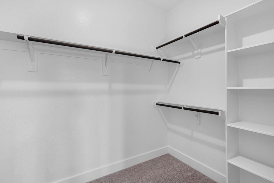 A stylish walk-in closet awaits, providing ample storage for your wardrobe and a little extra room for those cherished items.