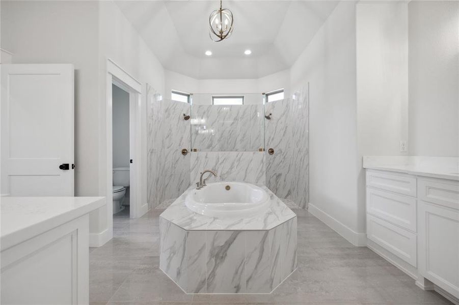 Full bathroom featuring vanity, tile patterned floors, plus walk in shower, and toilet