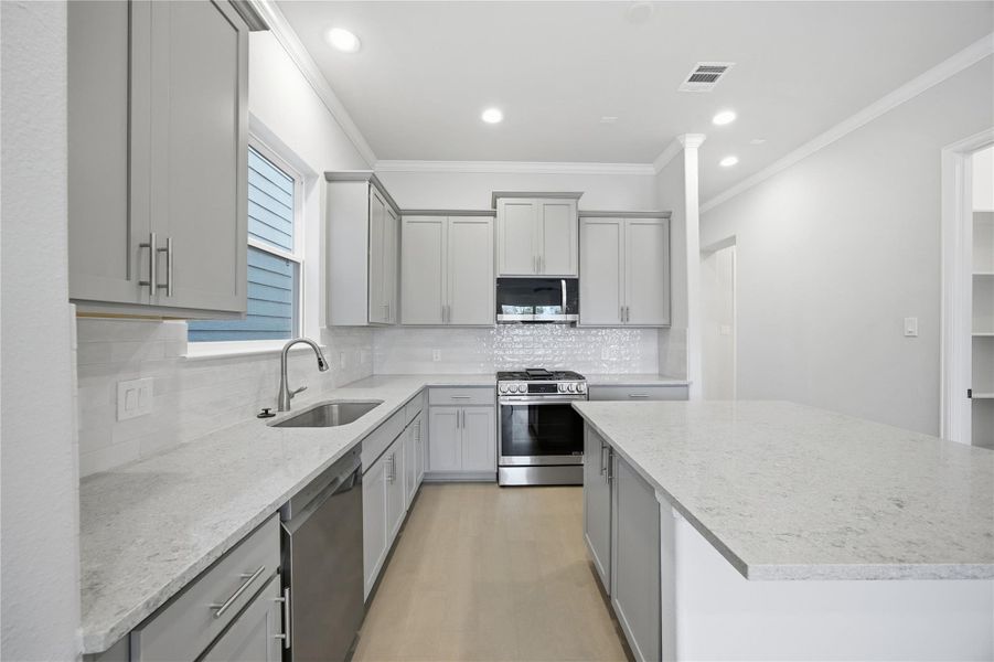 Premium Finishes Up Close – A closer look reveals LG’s sleek stainless steel appliances and a modern Moen faucet—blending form and function for a kitchen that’s as hardworking as it is beautiful.