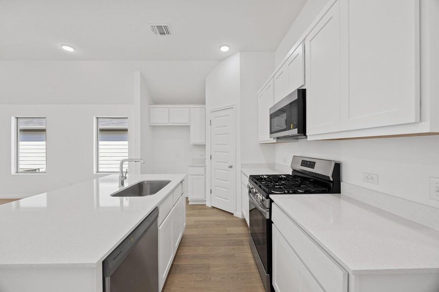 Kitchen in the Cypress home plan by Trophy Signature Homes – REPRESENTATIVE PHOTO