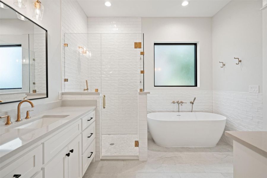 Luxurious primary bath with a spacious soaking tub, double vanity, and walk-in shower. Luxurious primary bath with a spacious soaking tub, double vanity, and walk-in shower.