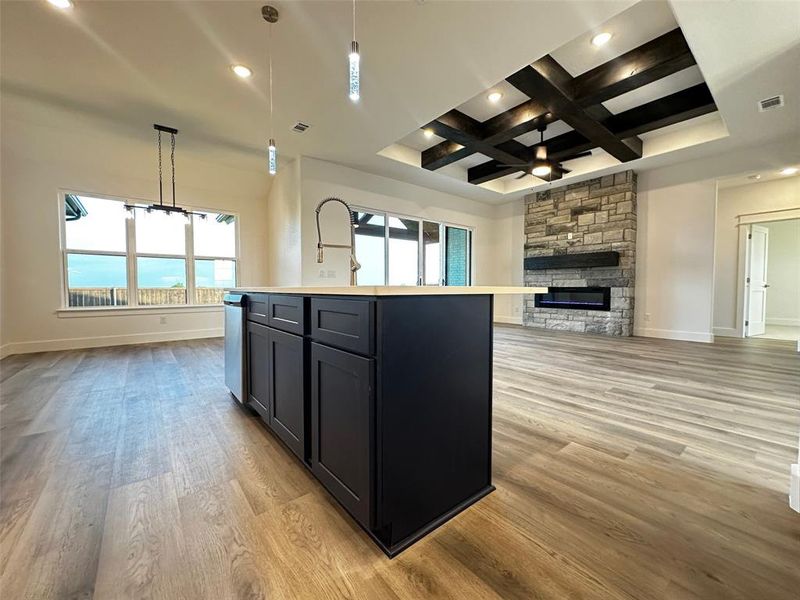 Kitchen with baseboards, open floor plan, light wood finished floors, and visible vents