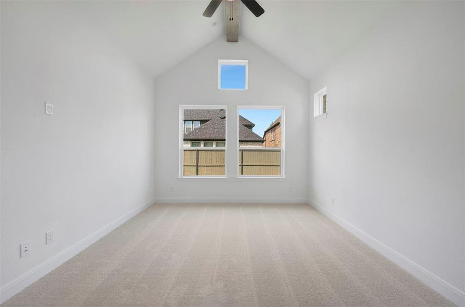 Spare room featuring light colored carpet and ceiling fan