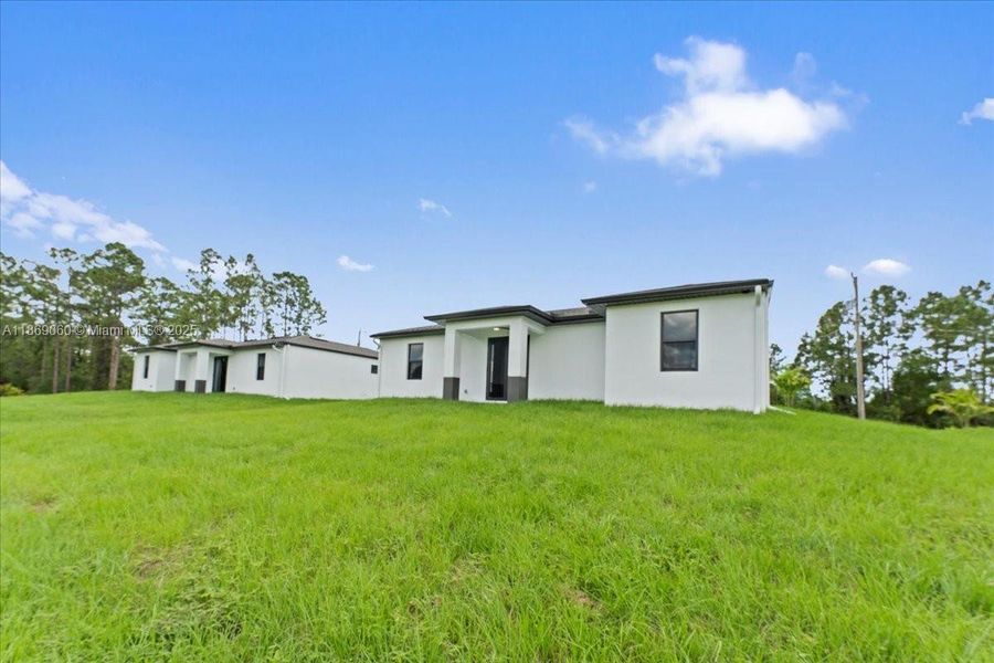 Front exterior of a new home in , Lehigh Acres, FL, highlighting curb appeal (Image 18). Front exterior of a new home in , Lehigh Acres, FL, highlighting curb appeal (Image 18).