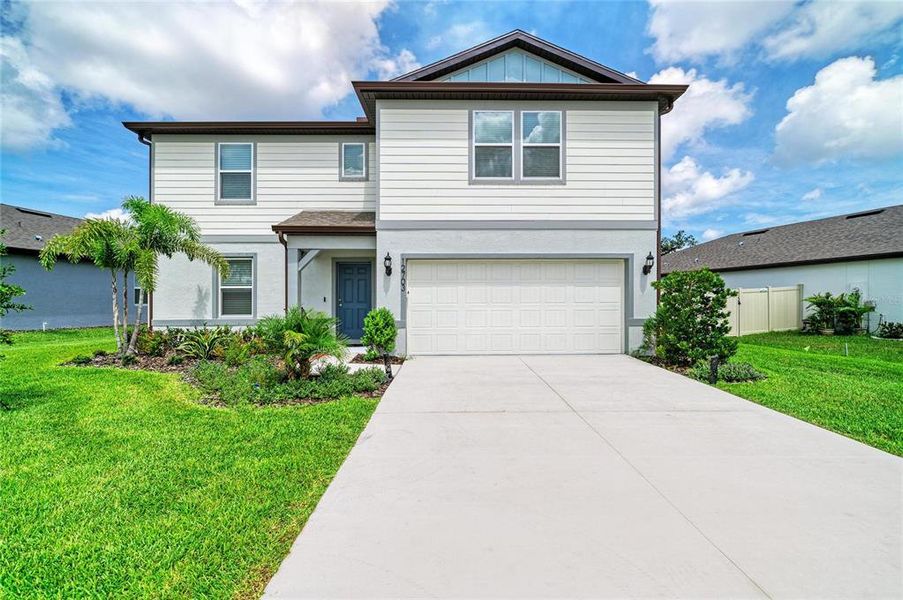 Front exterior of a new home in Oakfield Lakes, Parrish, FL, highlighting curb appeal (Image 1). Front exterior of a new home in Oakfield Lakes, Parrish, FL, highlighting curb appeal (Image 1).