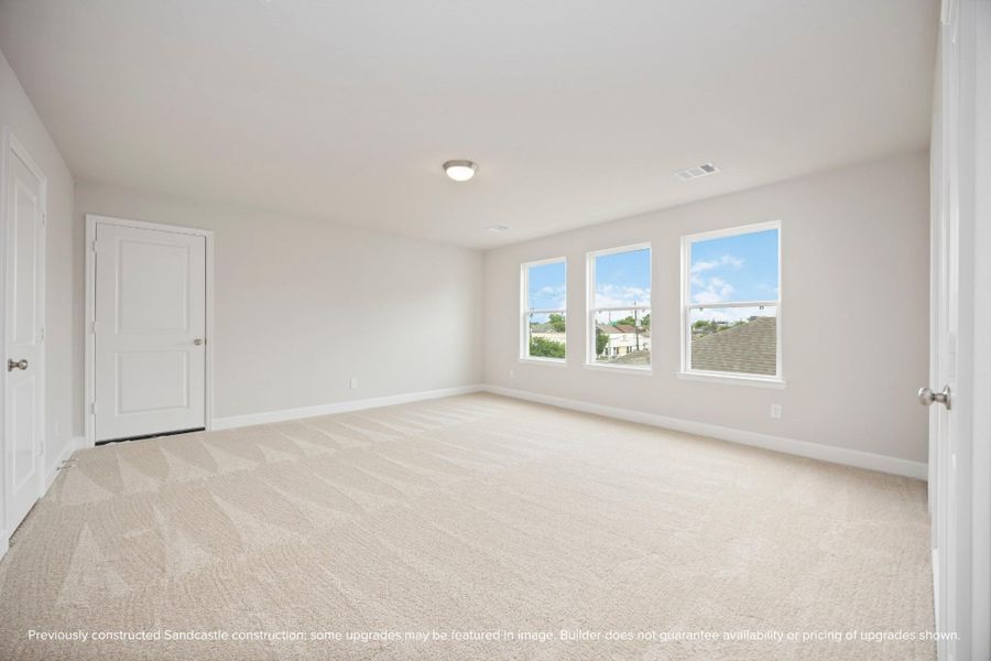 A remarkably large third-floor bedroom basks in brightness, featuring an ensuite bathroom and access to a substantial walk-in storage closet, ensuring privacy and comfort. A remarkably large third-floor bedroom basks in brightness, featuring an ensuite bathroom and access to a substantial walk-in storage closet, ensuring privacy and comfort.