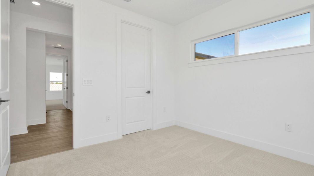 The Fifth Bedroom of a DRB Homes Grand Hawk which is offered as a home plan at Serengeti in Spring Hill, FL.