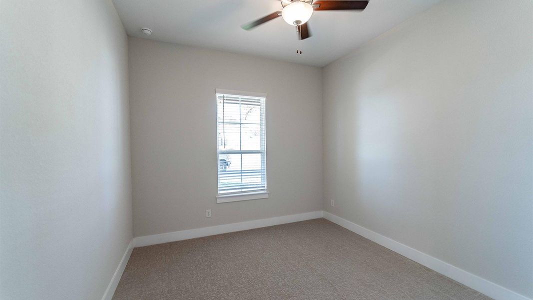 Empty room with light colored carpet and ceiling fan Empty room with light colored carpet and ceiling fan