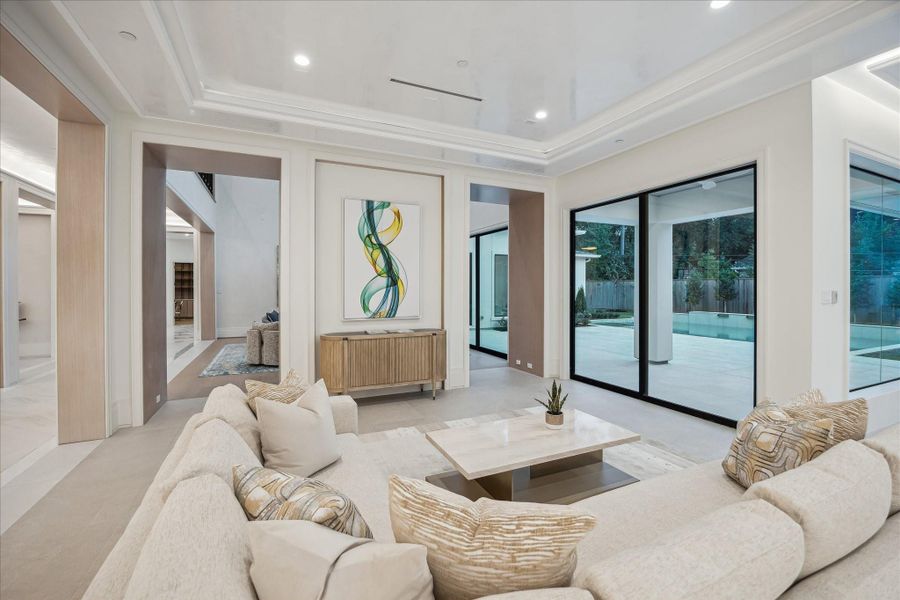 The family room’s expansive windows amplify daylight and capture serene outdoor views.