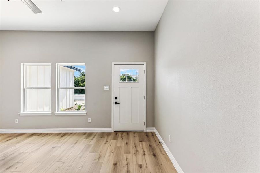 Doorway to outside with light wood-type flooring and ceiling fan